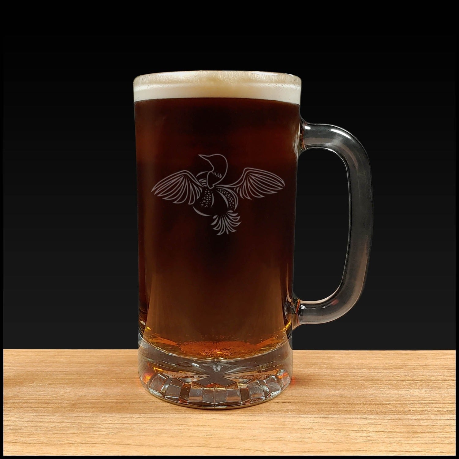 Loon with wings outstretched design on a 16oz handled Beer Mug containing a Dark Beer - Copyright Hues in Glass