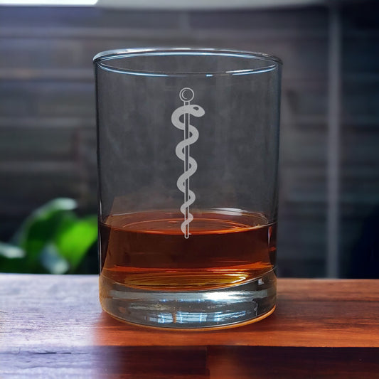 Whiskey Glass with a etched image of a Rod of Asclepius on it - Copyright Hues in Glass