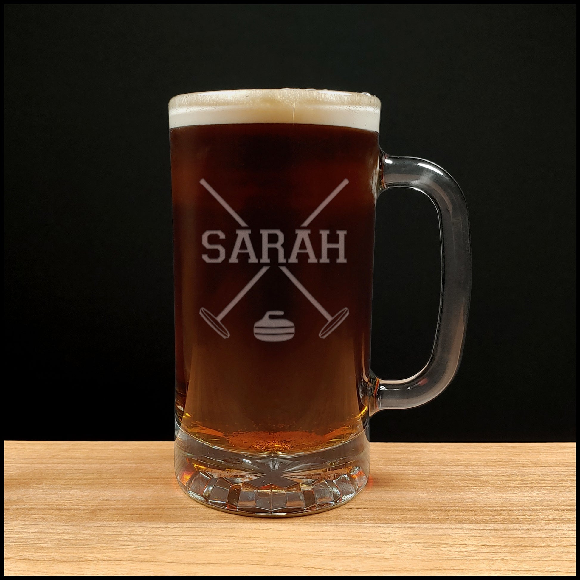 Curling Beer Mug with crossed broom and a stone at the bottom between the brooms- Copyright Hues in Glass