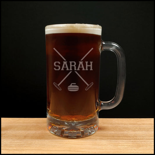 Curling Beer Mug with crossed broom and a stone at the bottom between the brooms- Copyright Hues in Glass