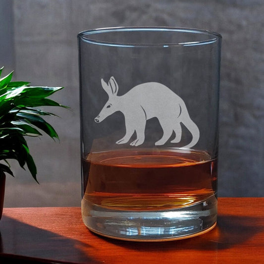 A 13 oz Whisky Glass with an etched Aardvark on it- Copyright Hues in Glass